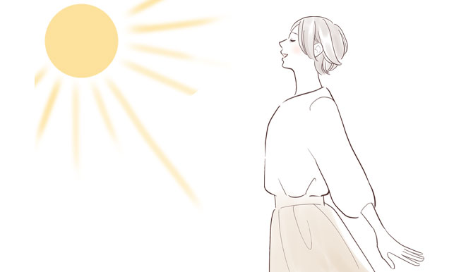 太陽の光を浴びる女性